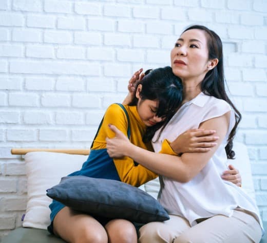 Asian mother comforting her child