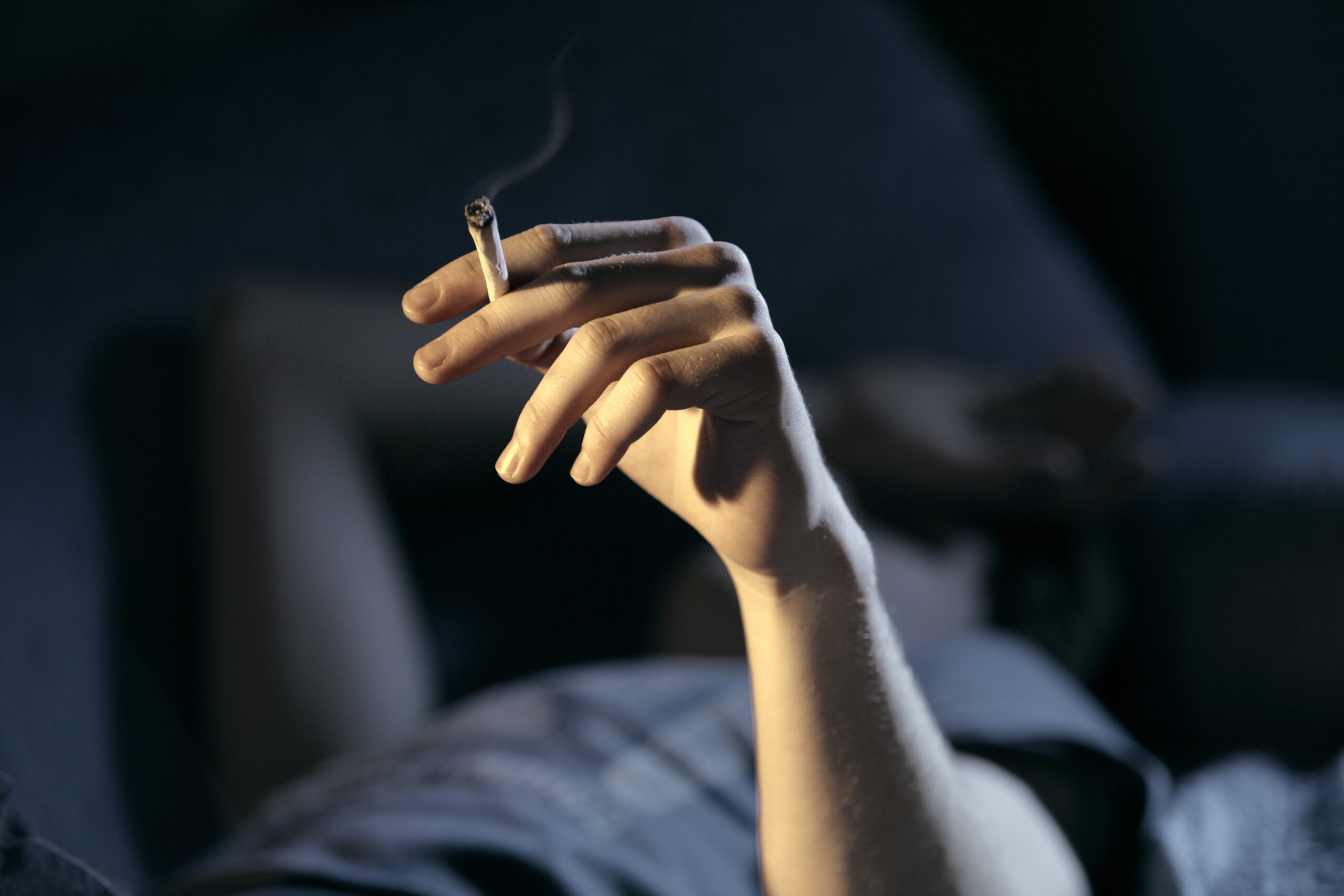 Teen holding cannabis joint